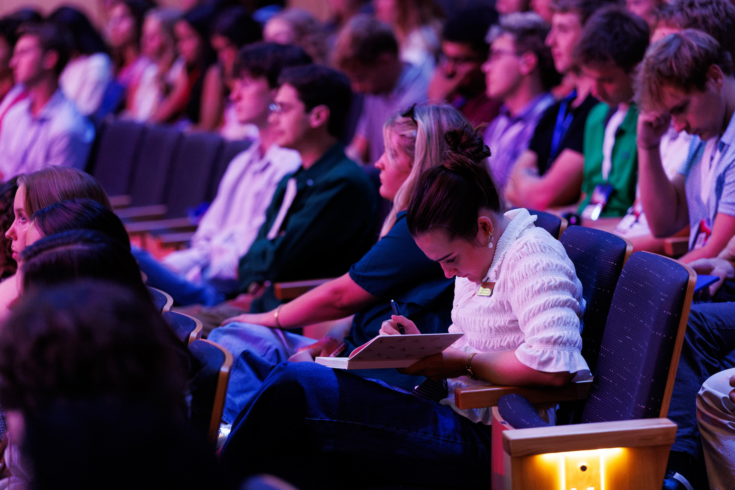 Employees listening during a large presentation
