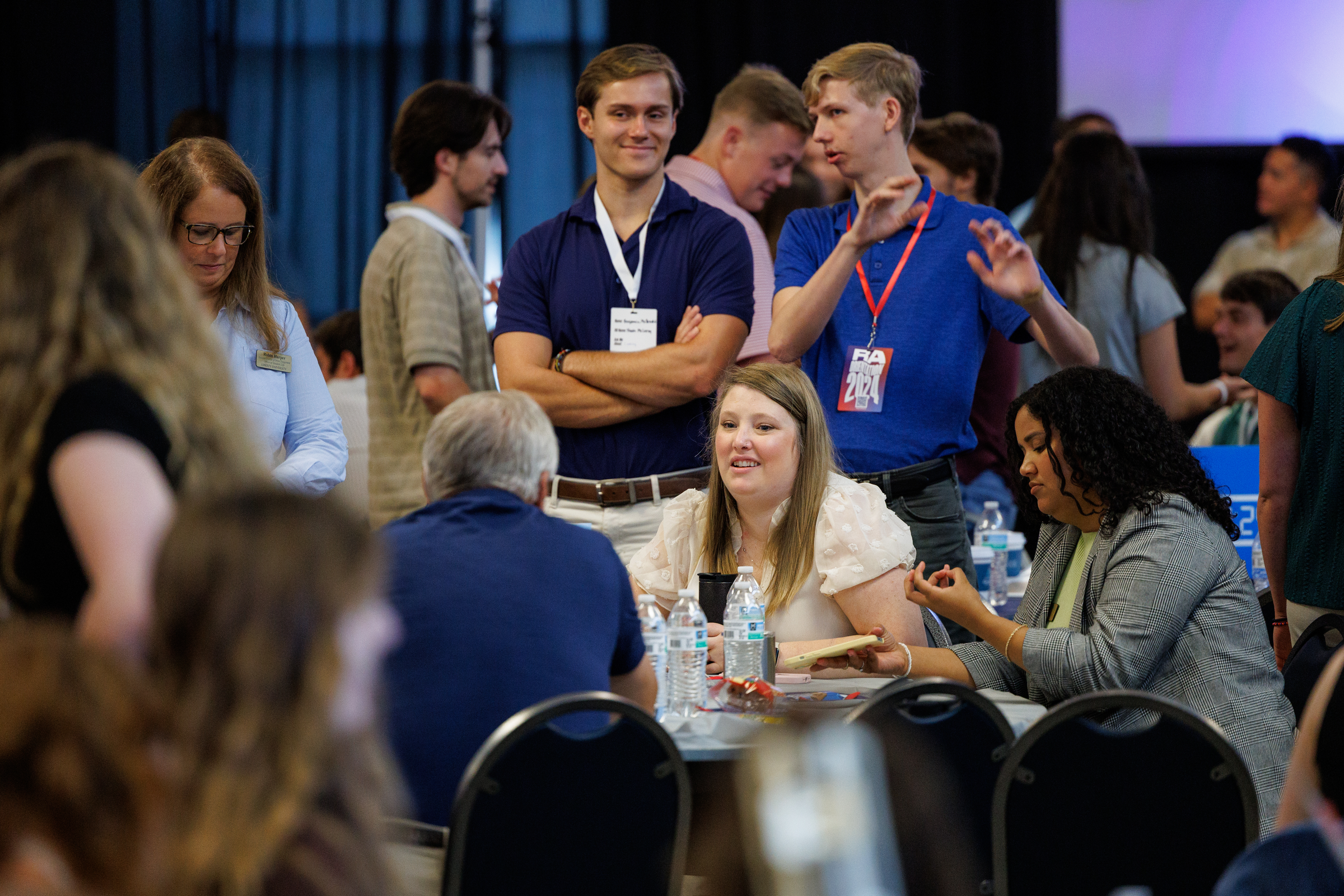 Employees talking in groups during an event